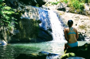 Women sitting in front of a waterfall